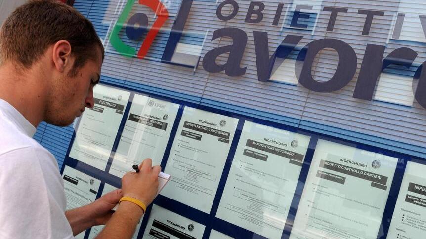 Un ragazzo davanti a una agenzia interinale