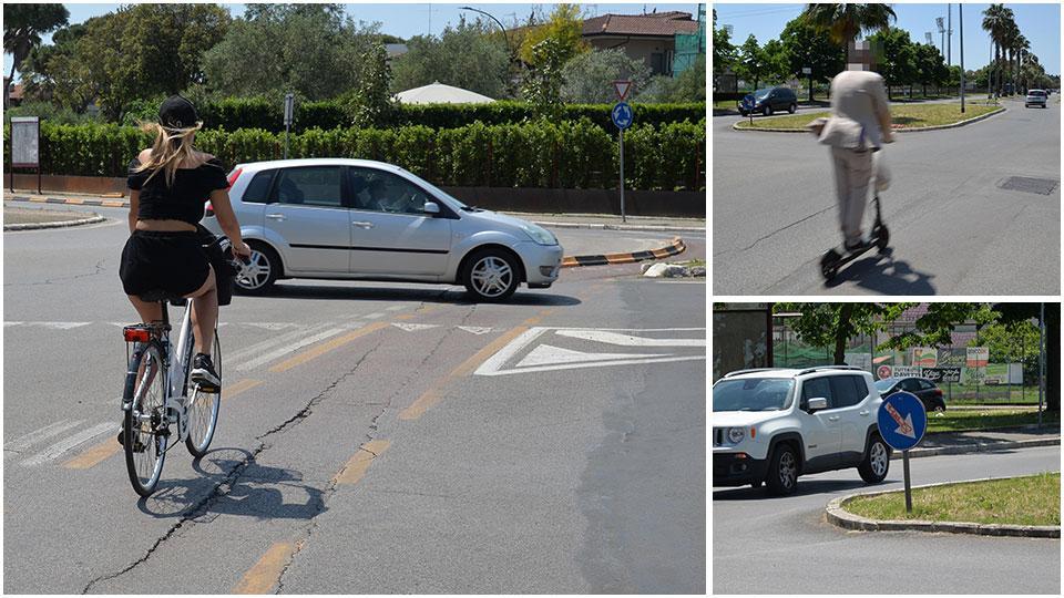 Una ciclista giunta da viale della Repubblica all’incrocio con via Cimabue, monopattino davanti alla “falsa rotatoria” tra via Giotto, viale della Repubblica e via don Sturzo Sotto un segnale che non era installato correttamente