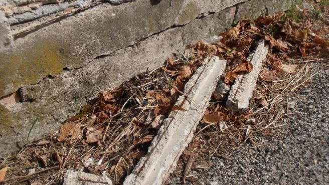 Dal marciapiede cadono i pezzi